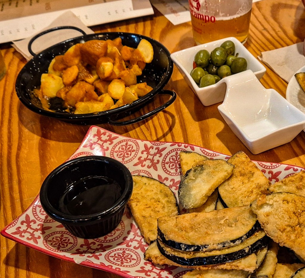 Tapas in Malaga: local croquetas, patatas bravas, and fried aubergines with honey.