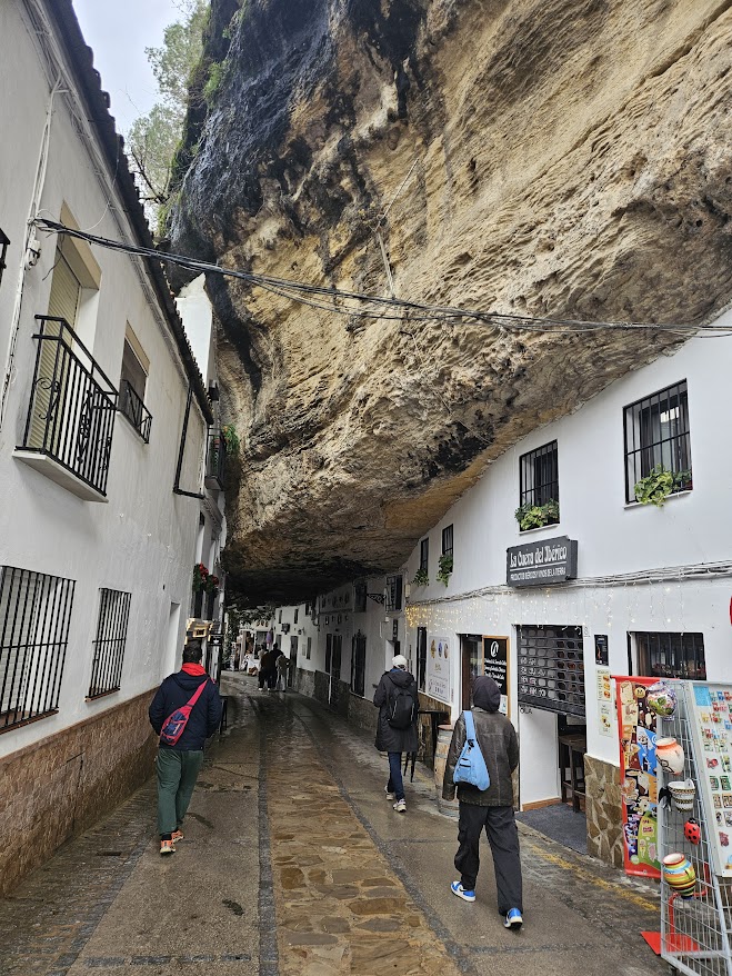 Restaurants and houses beneath the enormous overhanging cliff of Calle Cuevas del Sol, one of the most recognised and postcard perfect streets in Setenil de la bodegas.