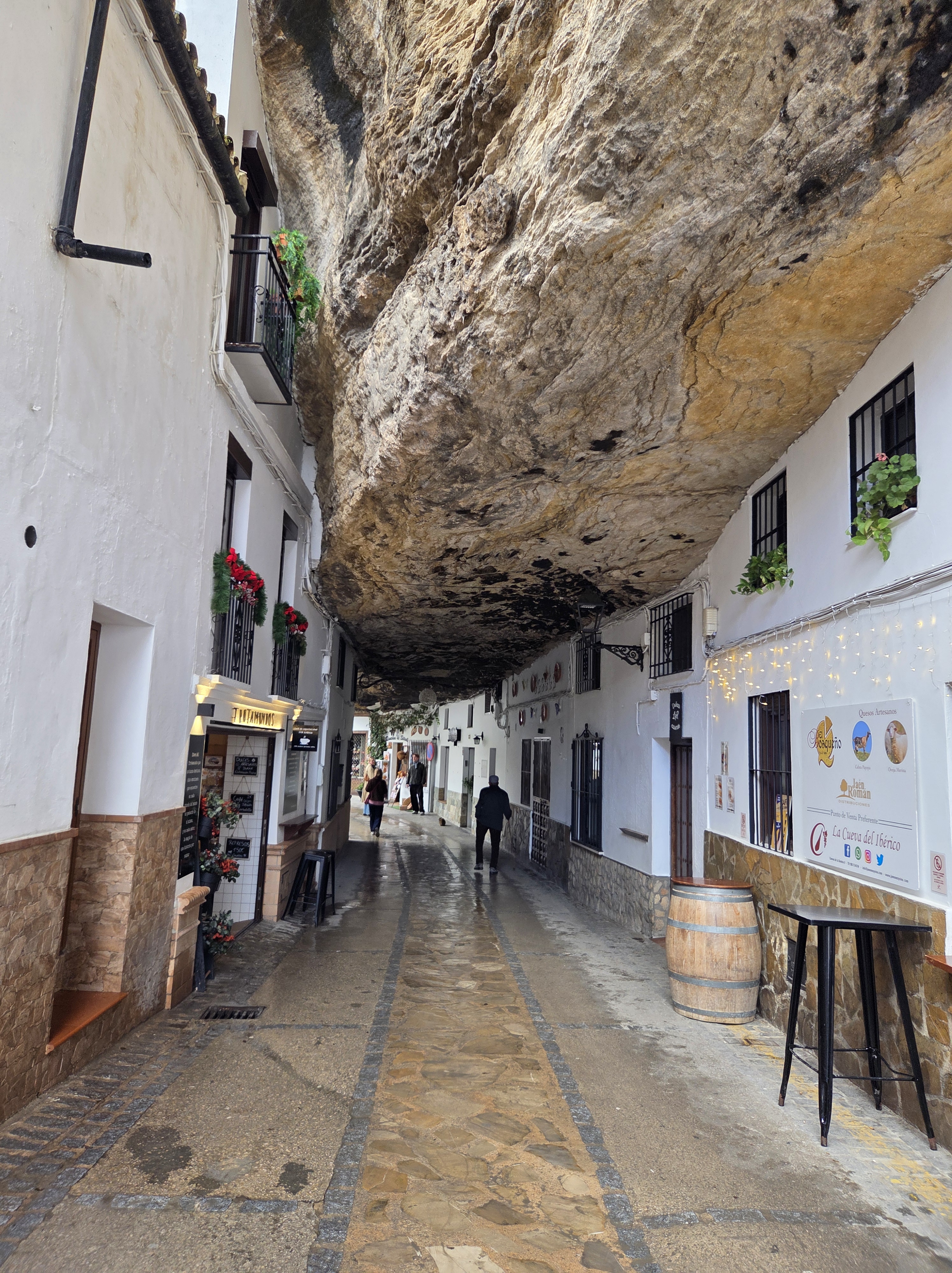 Restaurants and houses beneath the enormous overhanging cliff of Calle Cuevas del Sol, one of the most recognised and postcard perfect streets in Setenil de la bodegas.